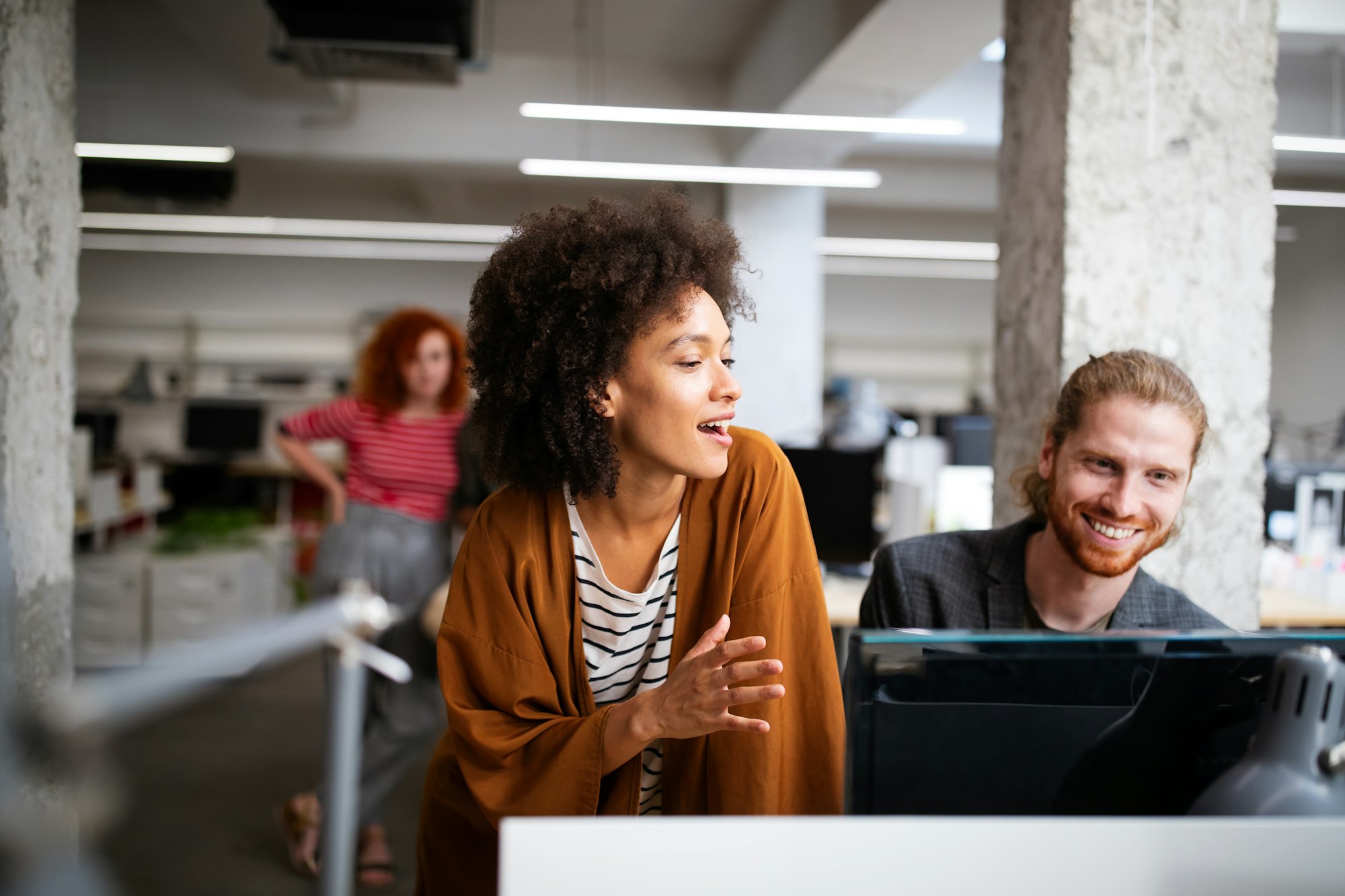 Programmers cooperating brainstorming at information technology company Programmers cooperating brainstorming at information technology company